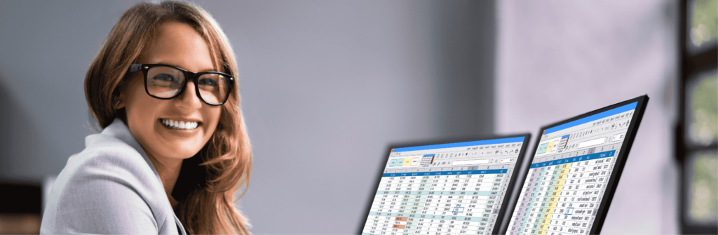 A smiling woman going over spreadsheets
