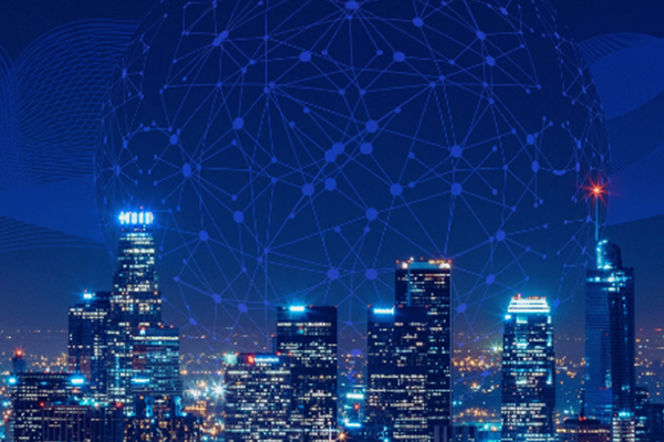 A city skyline at night with tall, illuminated skyscrapers. Above the buildings, a large digital network globe with connecting nodes and lines is superimposed, symbolizing technology and connectivity.