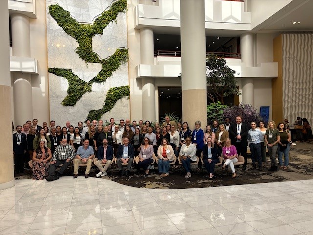 A group posing in the lobby of a building