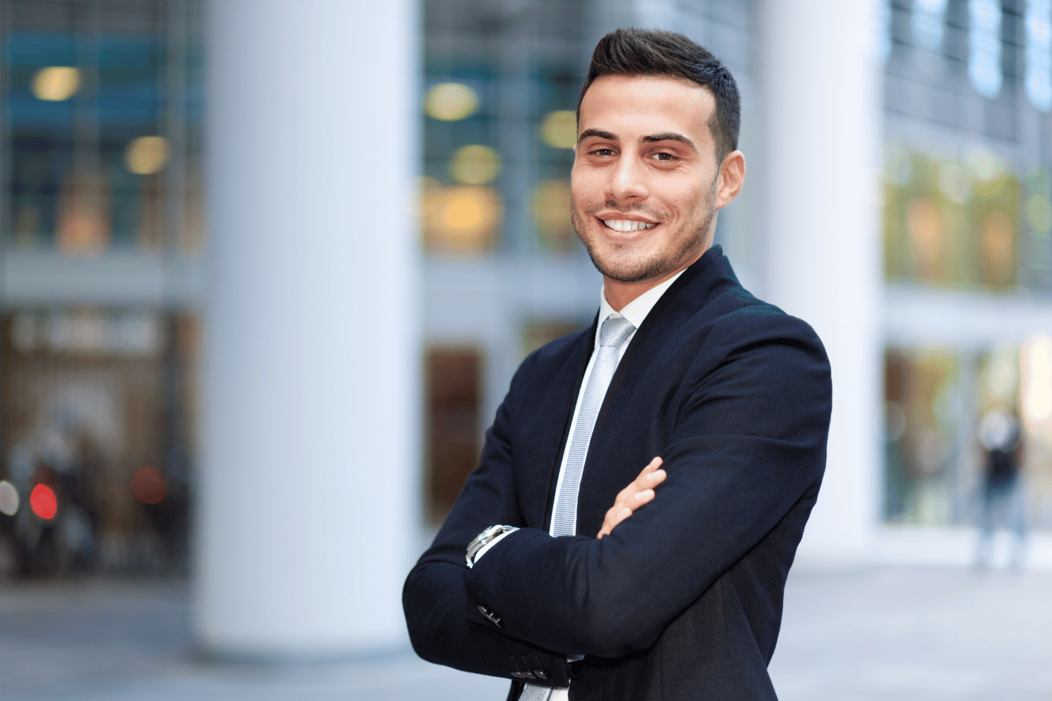 a young professional posing in front of an office