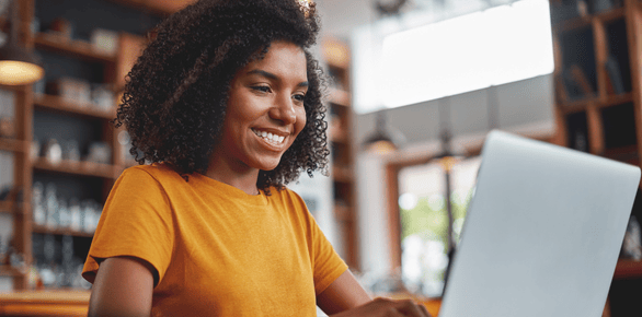 A smiling woman with a laptop