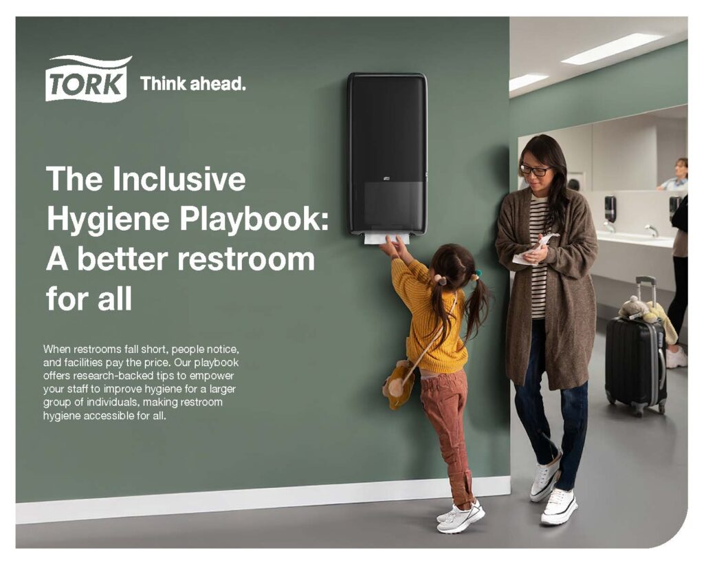 A woman and a young girl use a paper towel dispenser in a clean, modern restroom. The wall displays the Tork logo and text promoting The Inclusive Hygiene Playbook: A better restroom for all.