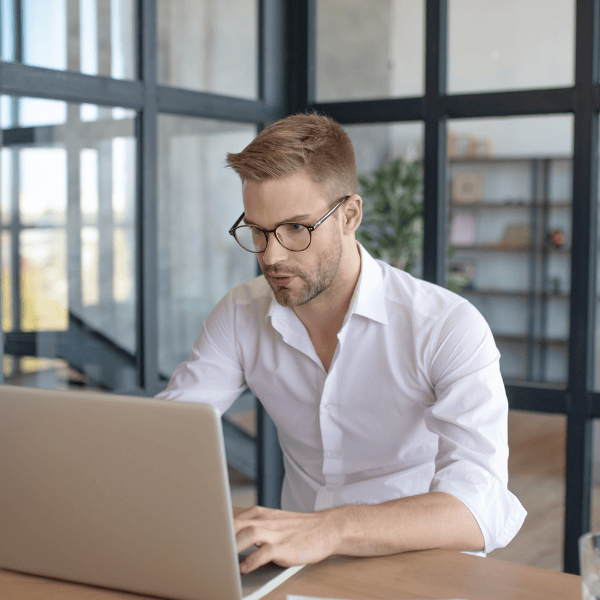 A man with glasses working at the office