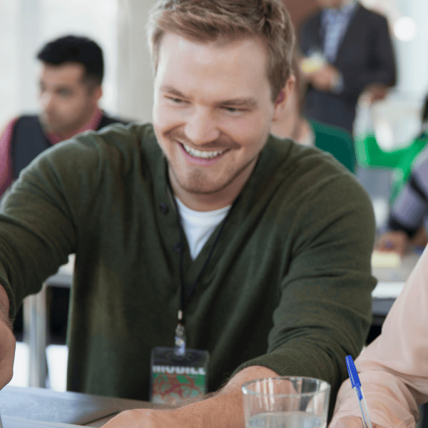 A smiling man working with a coworker